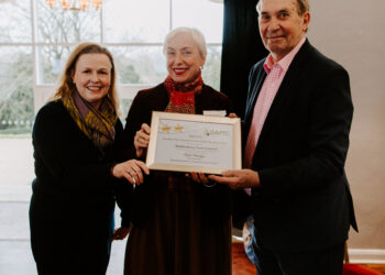 Image of Cllr Karen Tippins and Cllr Virginia Edwyn-Jones being presented with an award by Keith Stevens, Chairman of the National Association of Local Councils.